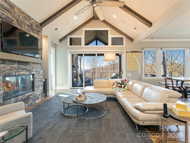 living room with beamed ceiling, a ceiling fan, visible vents, and high vaulted ceiling