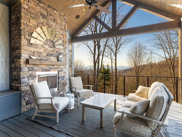 wooden deck with an outdoor living space with a fireplace and a ceiling fan