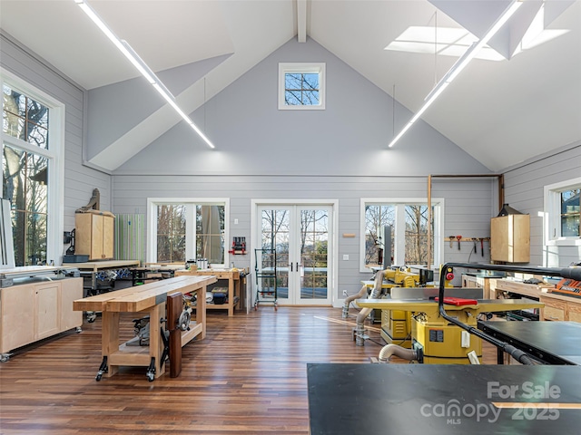 kitchen featuring a skylight, french doors, beamed ceiling, and wood finished floors