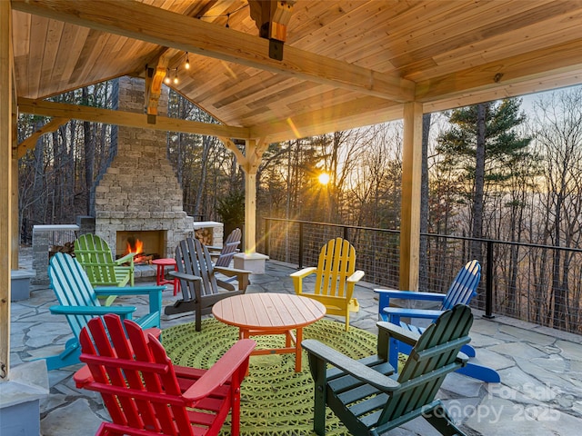 view of patio / terrace featuring a gazebo and an outdoor stone fireplace