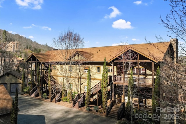 exterior space featuring stairs and an outbuilding