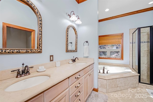 bathroom with a stall shower, a garden tub, and a sink