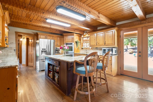 1620 London Rd, Mooresville, NC 28115 - kitchen featuring appliances with stainless steel finishes, wood ceiling, beamed ceiling, light wood finished floors, and a center island