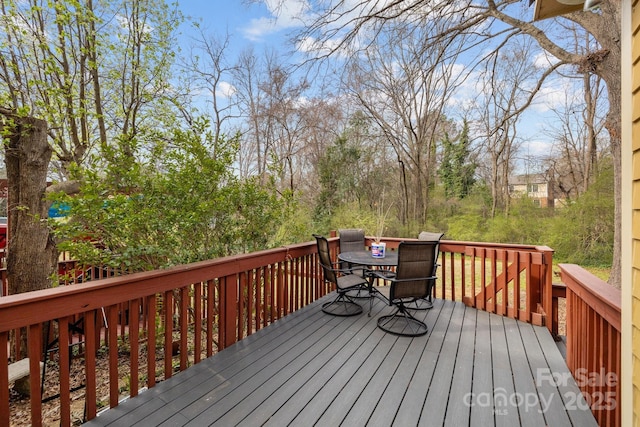 wooden terrace featuring outdoor dining space