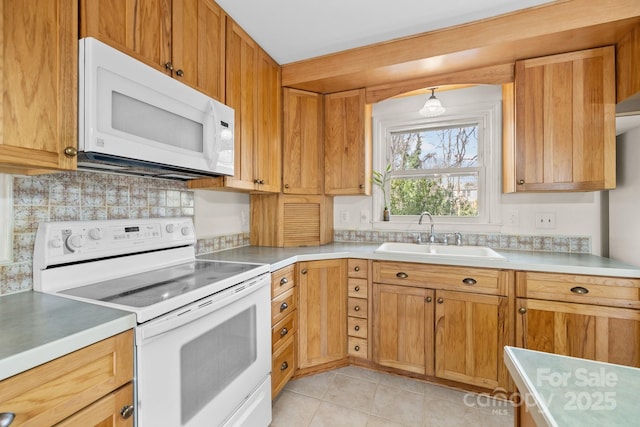 kitchen with light countertops, decorative backsplash, light tile patterned flooring, white appliances, and a sink