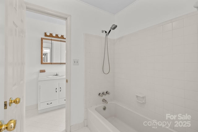 bathroom featuring vanity, washtub / shower combination, baseboards, and tile patterned flooring