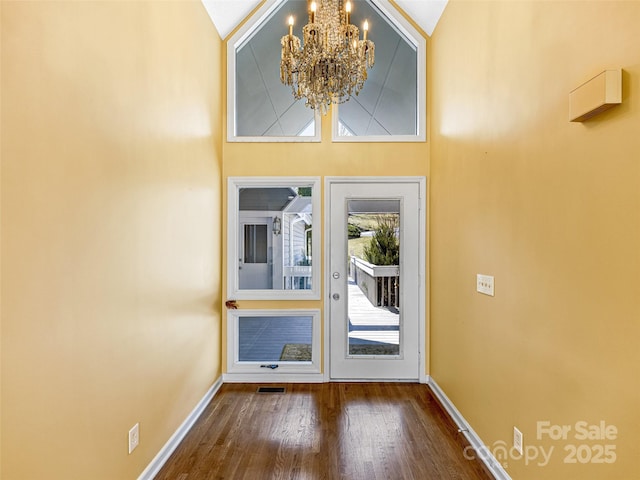 foyer featuring visible vents, baseboards, a notable chandelier, and dark wood-style flooring