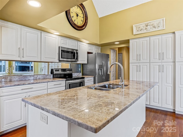 kitchen featuring a sink, stainless steel appliances, dark wood-style floors, and white cabinets