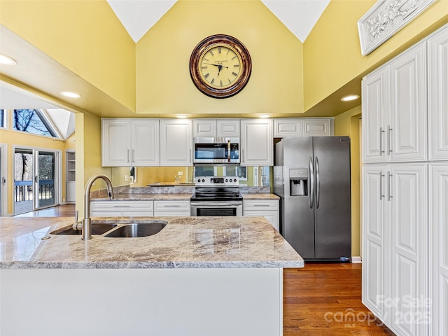 kitchen featuring white cabinetry, high vaulted ceiling, appliances with stainless steel finishes, and a sink