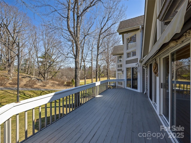 wooden deck with a lawn