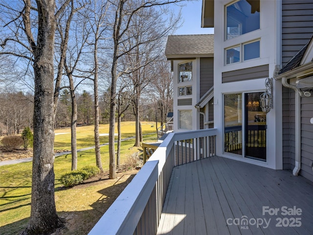 wooden terrace with a yard