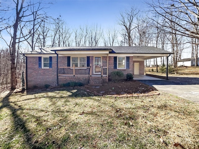 single story home with an attached carport, a front yard, driveway, a porch, and brick siding