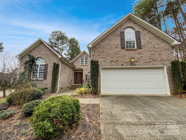 traditional home featuring crawl space, brick siding, concrete driveway, and an attached garage