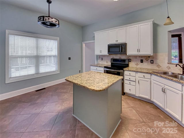 kitchen with tasteful backsplash, visible vents, black microwave, stainless steel range with electric stovetop, and a sink