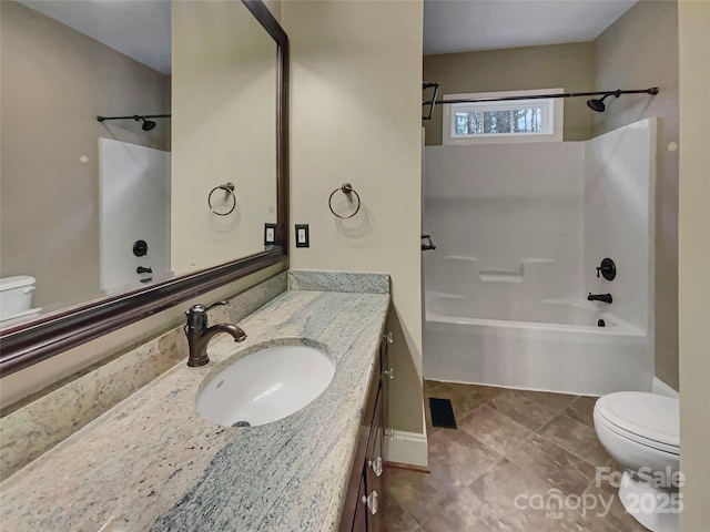 bathroom with toilet, vanity, and bathtub / shower combination