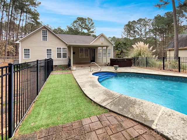 view of pool featuring a fenced in pool, a yard, a fenced backyard, a hot tub, and a patio area