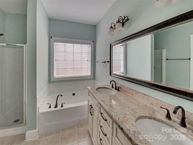 bathroom with a shower stall, tile patterned floors, and a sink