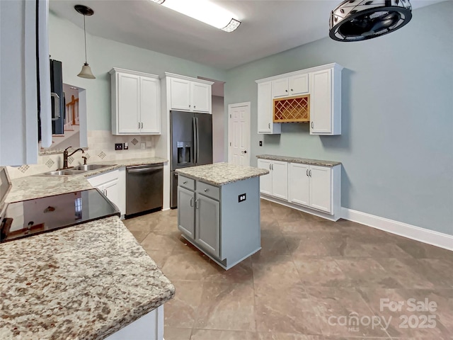 kitchen with backsplash, dishwasher, refrigerator with ice dispenser, white cabinets, and a sink