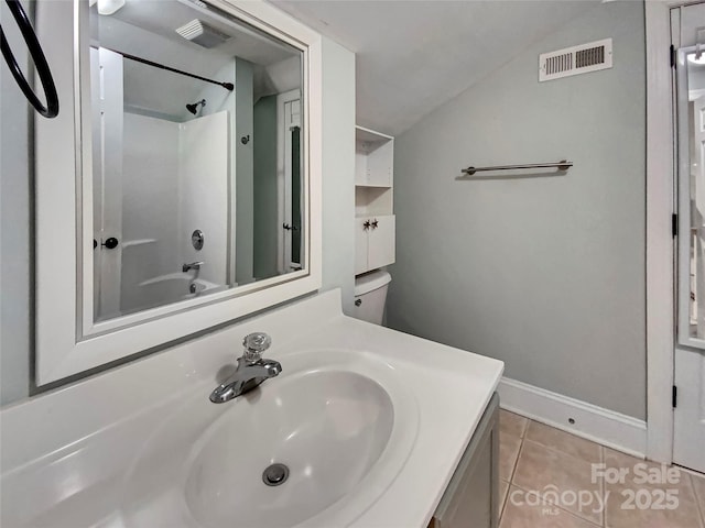 bathroom featuring vanity, visible vents, lofted ceiling, shower / washtub combination, and tile patterned floors