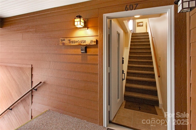 staircase with wooden walls