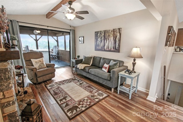 living area with baseboards, lofted ceiling with beams, ceiling fan, and wood finished floors