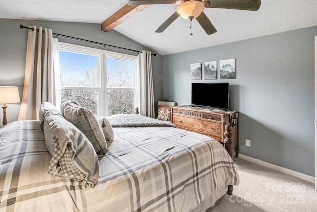 carpeted bedroom featuring vaulted ceiling with beams, a ceiling fan, and baseboards