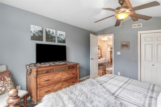 bedroom featuring a closet, visible vents, ceiling fan with notable chandelier, and vaulted ceiling