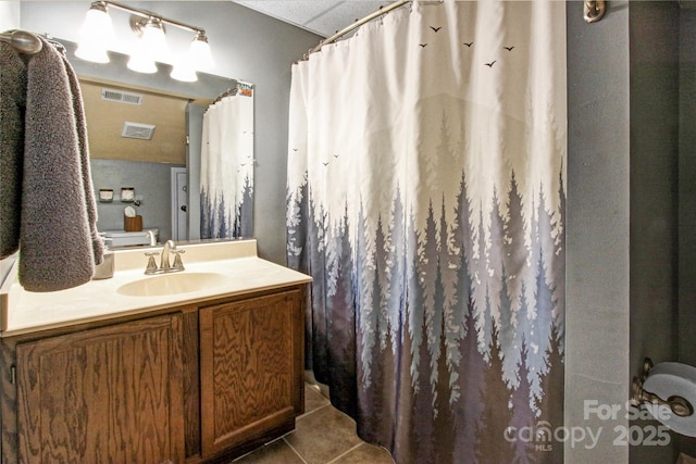 full bath featuring tile patterned floors, visible vents, curtained shower, and vanity