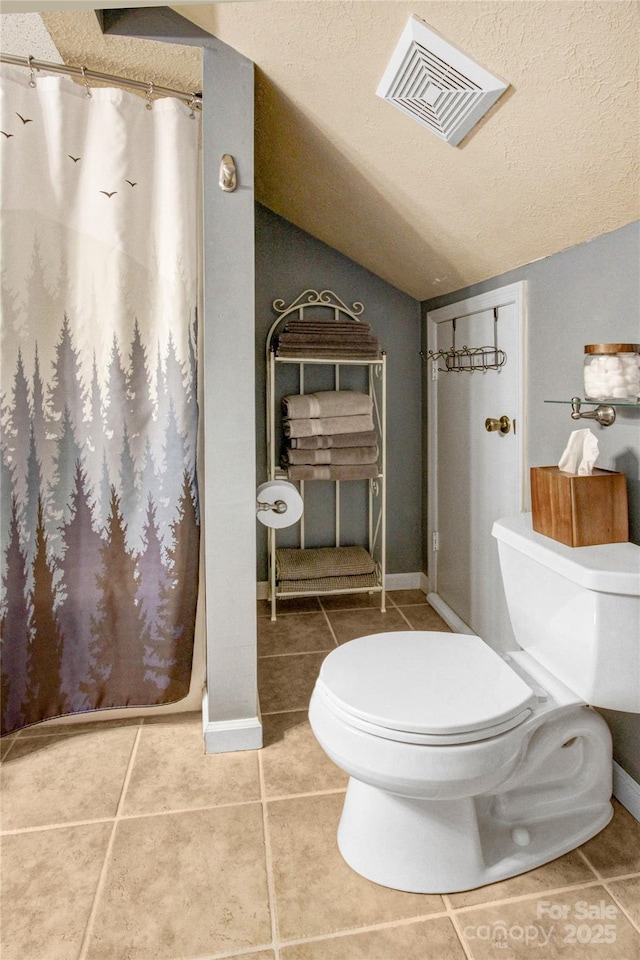 full bath featuring tile patterned floors, visible vents, toilet, and a textured ceiling