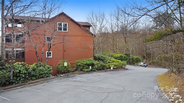 view of side of home with uncovered parking