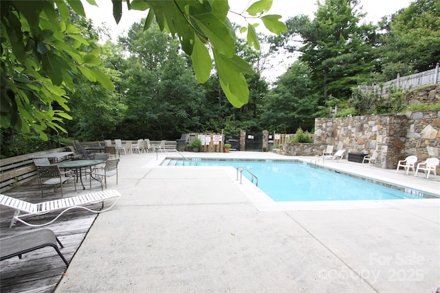 pool featuring a patio area and fence