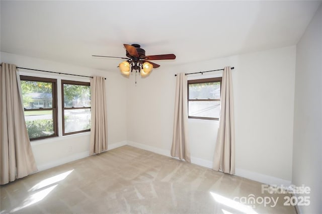 unfurnished room with light carpet, baseboards, and ceiling fan