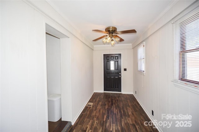 interior space with a healthy amount of sunlight, baseboards, ceiling fan, and wood finished floors