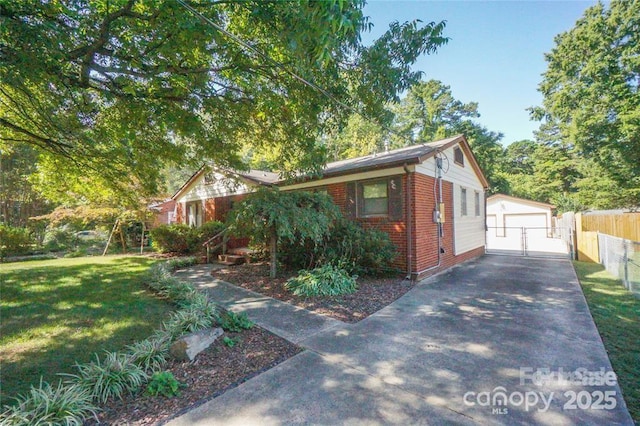 bungalow featuring brick siding, a detached garage, fence, a front yard, and an outbuilding