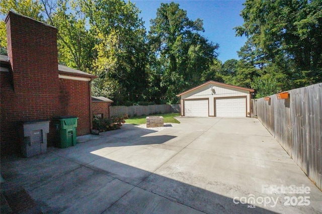 detached garage featuring fence