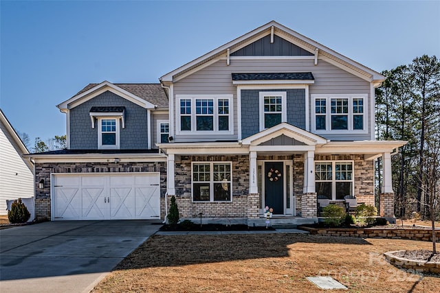 view of front of property featuring concrete driveway, a garage, board and batten siding, and stone siding