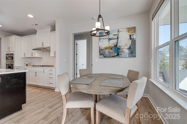 dining area featuring visible vents, baseboards, recessed lighting, light wood-type flooring, and a chandelier