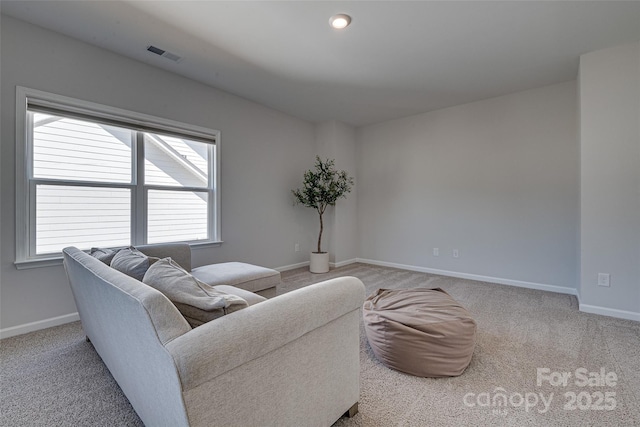 carpeted living room featuring visible vents and baseboards