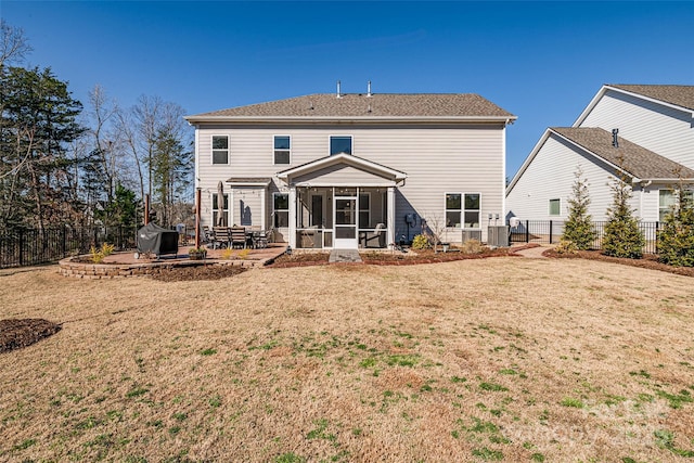 back of property featuring a patio, a yard, a fenced backyard, central AC, and a sunroom