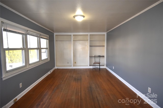 unfurnished room featuring baseboards, dark wood-style flooring, and ornamental molding