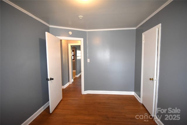 interior space featuring crown molding, wood finished floors, and baseboards