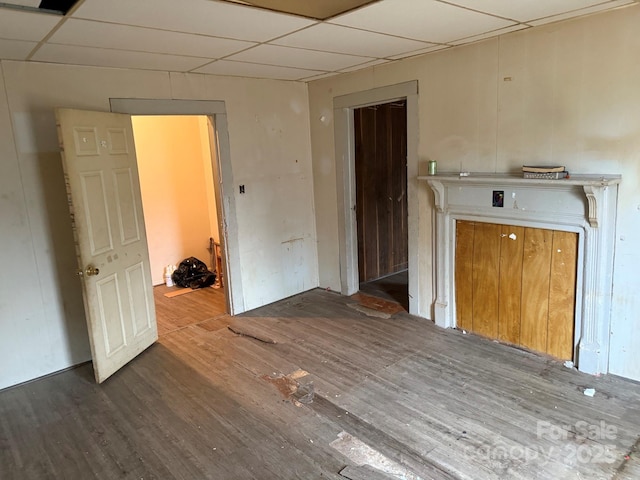 spare room featuring wood finished floors and a drop ceiling