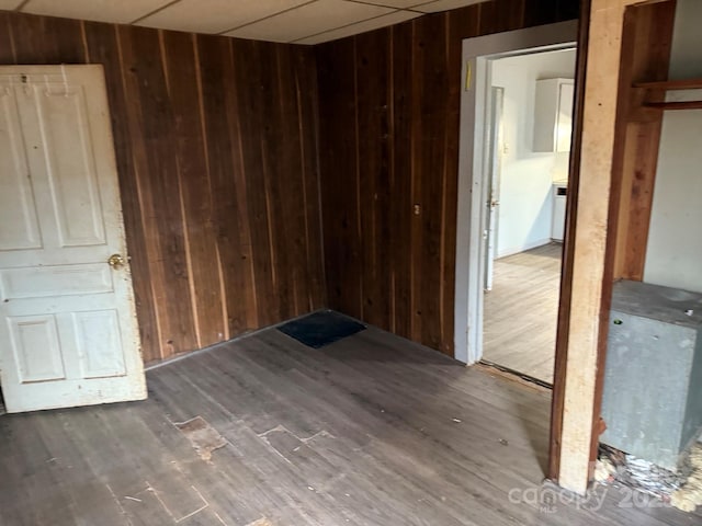 empty room featuring wood walls and wood finished floors