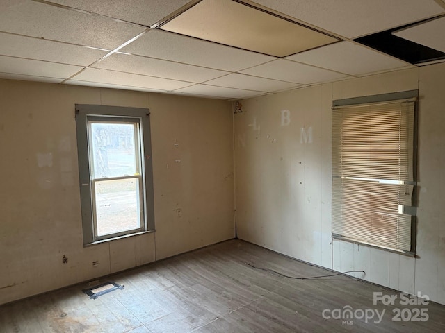 unfurnished room featuring a paneled ceiling