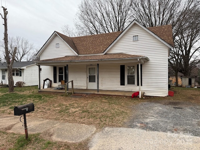 view of front of home with a porch and a shingled roof