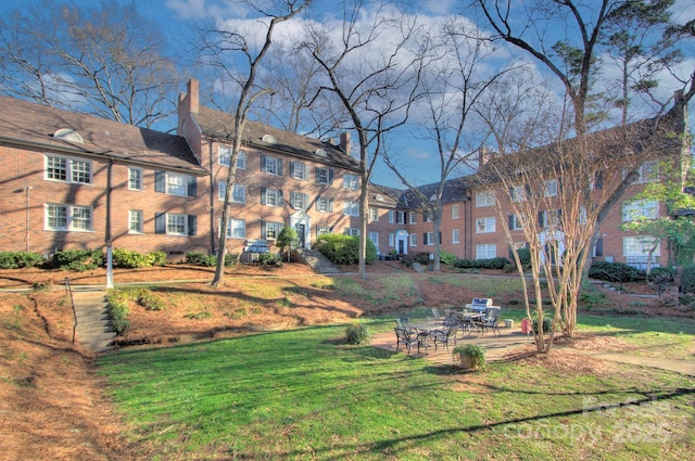 view of community with a patio and a yard