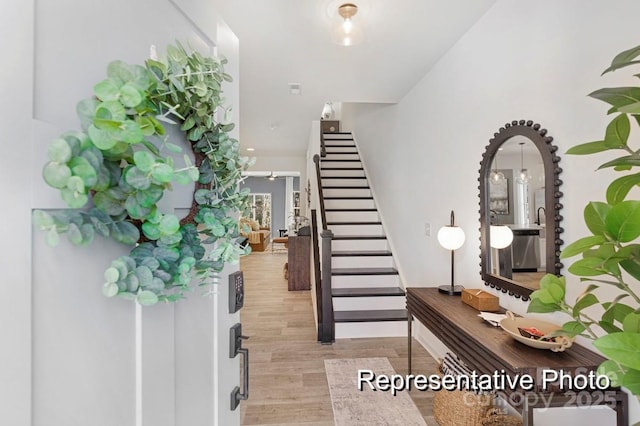 foyer with stairway and light wood finished floors