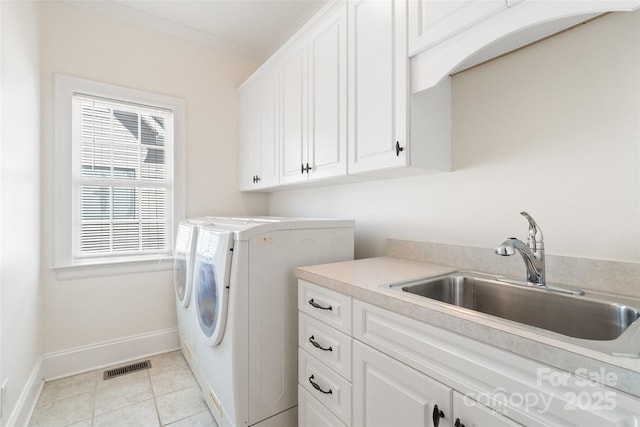 clothes washing area with light tile patterned floors, visible vents, cabinet space, a sink, and washing machine and dryer