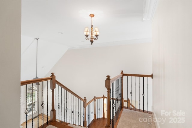 stairs with baseboards, high vaulted ceiling, crown molding, and an inviting chandelier