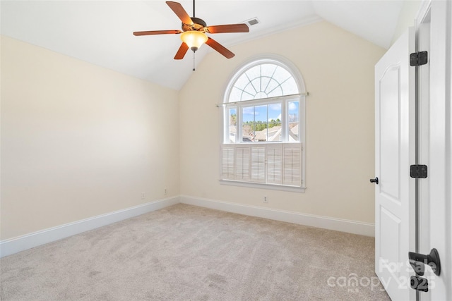 unfurnished room with baseboards, light carpet, ceiling fan, and vaulted ceiling